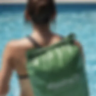 A person using a waterproof bag after swimming in a pool